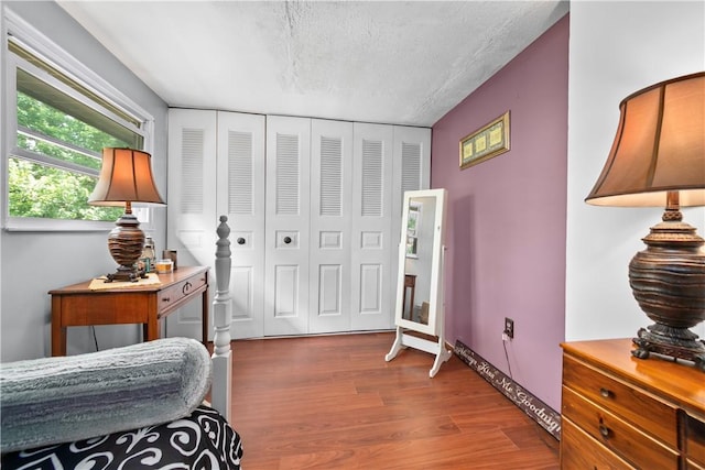 301 Holland Ct, Findlay Twp, PA 15108 - bedroom featuring wood finished floors, a textured ceiling, and a closet