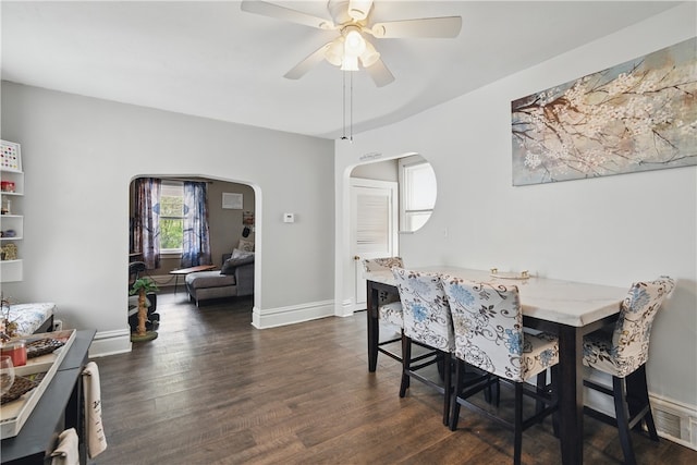 302 Midland Ave, Carnegie, PA 15106 - dining area with dark wood-type flooring, arched walkways, and a ceiling fan