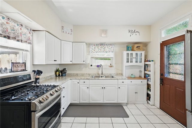 302 Midland Ave, Carnegie, PA 15106 - kitchen with stainless steel gas range, light tile patterned floors, white cabinetry, and light stone countertops