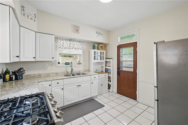 302 Midland Ave, Carnegie, PA 15106 - kitchen featuring freestanding refrigerator, white cabinets, plenty of natural light, and light tile patterned floors
