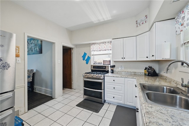 302 Midland Ave, Carnegie, PA 15106 - kitchen with stainless steel appliances, white cabinets, light countertops, and light tile patterned floors