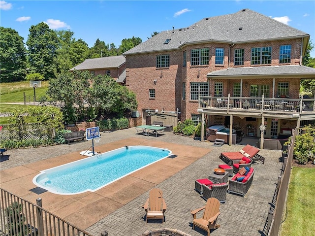548 Lang Rd, Sewickley Heights, PA 15143 - view of pool with a hot tub, a patio, a deck, and an outdoor living space with a fire pit