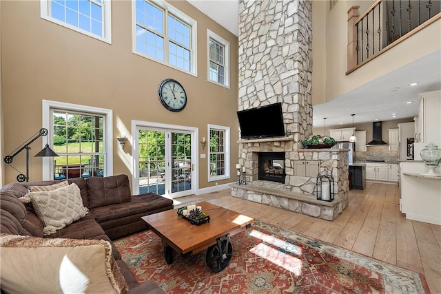 548 Lang Rd, Sewickley Heights, PA 15143 - living area with a high ceiling, light wood-style flooring, and a fireplace