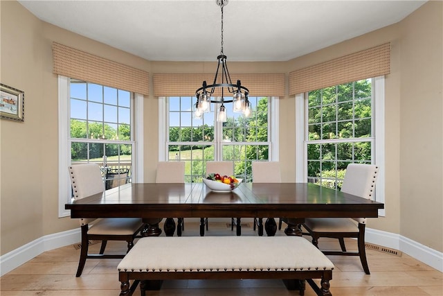 548 Lang Rd, Sewickley Heights, PA 15143 - dining space with a chandelier, light wood finished floors, and healthy amount of natural light