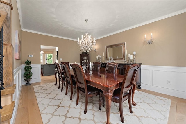 548 Lang Rd, Sewickley Heights, PA 15143 - dining room featuring a chandelier, light wood-style floors, crown molding, and a wainscoted wall