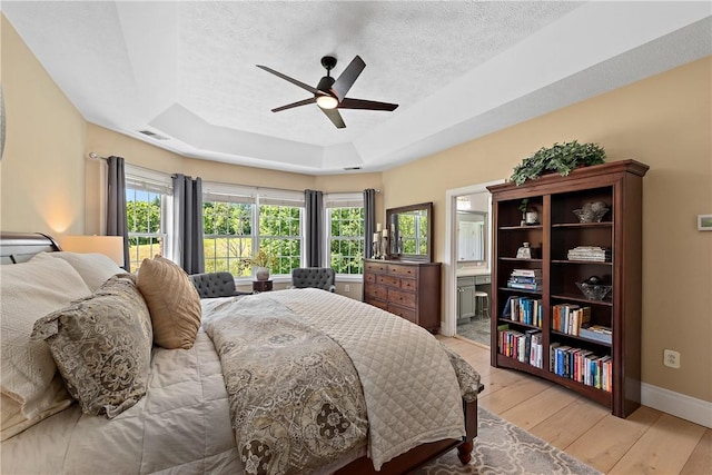 548 Lang Rd, Sewickley Heights, PA 15143 - bedroom with a raised ceiling, light wood finished floors, a textured ceiling, and a ceiling fan