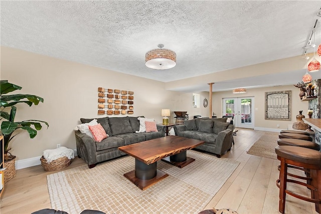 548 Lang Rd, Sewickley Heights, PA 15143 - living room with light wood-type flooring, french doors, and a textured ceiling