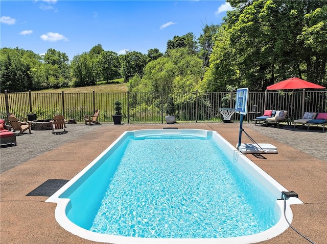 548 Lang Rd, Sewickley Heights, PA 15143 - view of swimming pool with a fire pit, a patio, and view of wooded area