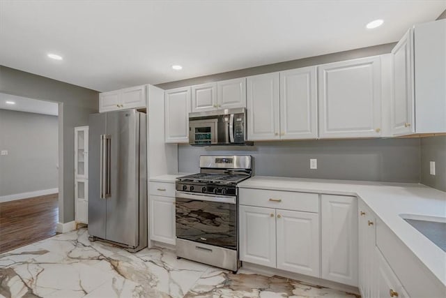 5241 Gardenville, Bethel Park, PA 15236 - kitchen featuring appliances with stainless steel finishes, light countertops, white cabinetry, light marble finish floors, and recessed lighting