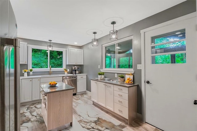 5241 Gardenville, Bethel Park, PA 15236 - kitchen featuring appliances with stainless steel finishes, white cabinetry, decorative light fixtures, and a center island