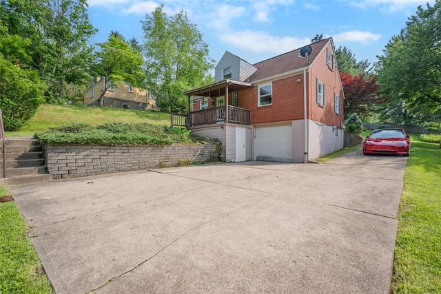 345 Franklin Dr, Peters Twp, PA 15241 - view of side of home with a garage, driveway, brick siding, and a yard