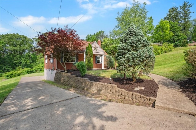 345 Franklin Dr, Peters Twp, PA 15241 - obstructed view of property featuring a front lawn, driveway, and a chimney