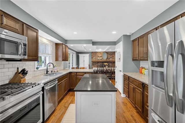 130 Kent Dr, Upper St Clair, PA 15241 - kitchen featuring stainless steel appliances, light wood-style floors, decorative backsplash, a kitchen island, and recessed lighting