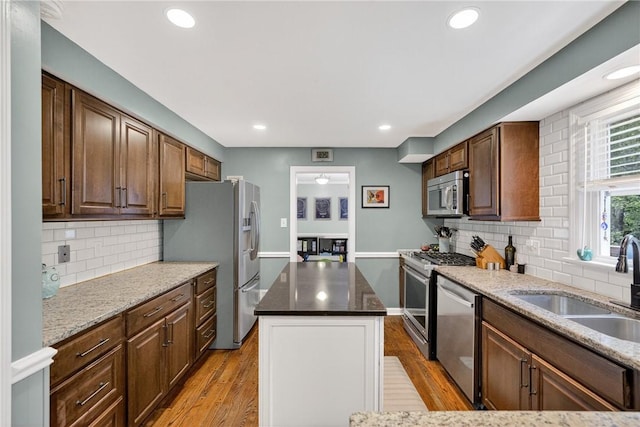 130 Kent Dr, Upper St Clair, PA 15241 - kitchen featuring stainless steel appliances, light wood-type flooring, a kitchen island, tasteful backsplash, and recessed lighting