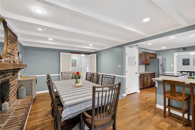 130 Kent Dr, Upper St Clair, PA 15241 - dining space with beamed ceiling, light wood finished floors, recessed lighting, and a brick fireplace