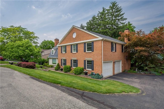 1061 Apple Hill Ln, Mccandless, PA 15101 - colonial inspired home with a chimney, an attached garage, driveway, and brick siding