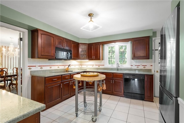 1061 Apple Hill Ln, Mccandless, PA 15101 - kitchen with black appliances, decorative backsplash, a chandelier, light tile patterned flooring, and glass insert cabinets