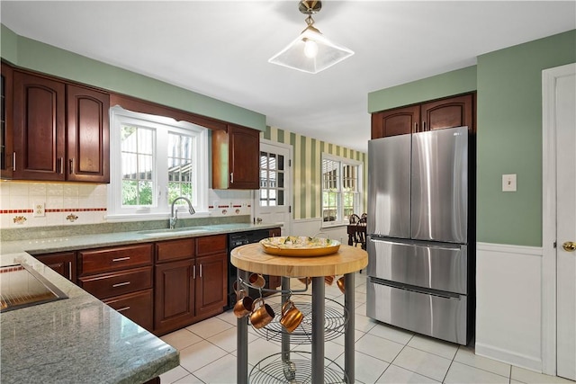 1061 Apple Hill Ln, Mccandless, PA 15101 - kitchen with freestanding refrigerator, dishwashing machine, light tile patterned flooring, decorative backsplash, and light stone counters