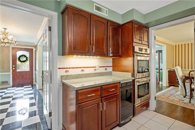 1061 Apple Hill Ln, Mccandless, PA 15101 - kitchen with stainless steel double oven, crown molding, light stone countertops, a chandelier, and light floors