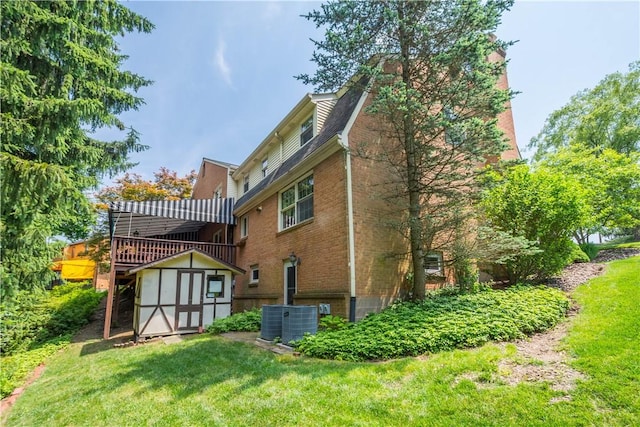 1061 Apple Hill Ln, Mccandless, PA 15101 - rear view of house with a storage shed, brick siding, a lawn, and a deck