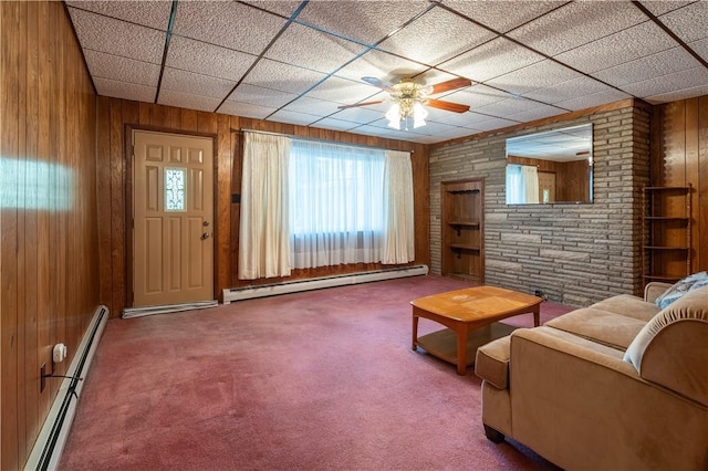 2509 Spring St, Arlington, PA 15210 - living area featuring a baseboard radiator, wood walls, healthy amount of natural light, carpet floors, and a drop ceiling