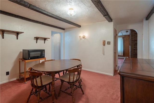 2509 Spring St, Arlington, PA 15210 - dining room featuring arched walkways, carpet flooring, and beam ceiling