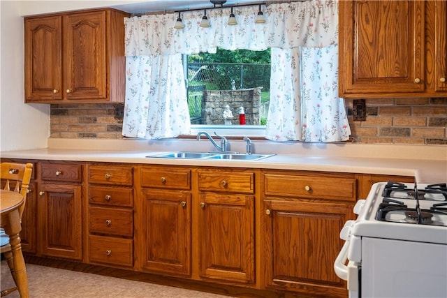 2509 Spring St, Arlington, PA 15210 - kitchen featuring brown cabinets, light countertops, white gas range, and decorative backsplash