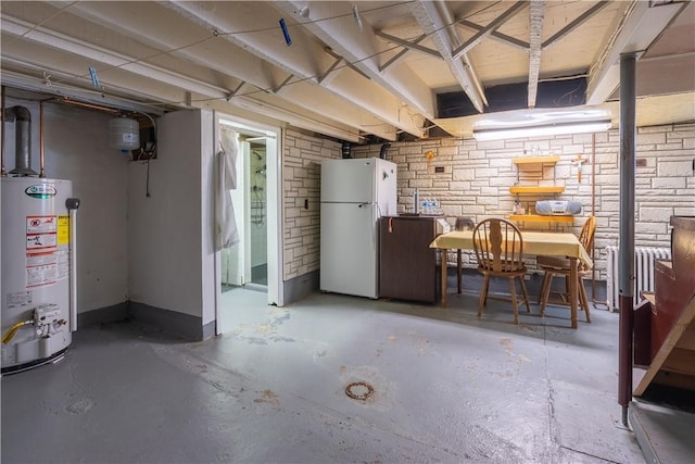 2509 Spring St, Arlington, PA 15210 - unfinished below grade area with freestanding refrigerator, water heater, and brick wall