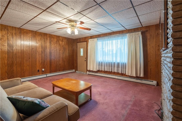 2509 Spring St, Arlington, PA 15210 - carpeted living room featuring a baseboard heating unit, ceiling fan, wood walls, and a paneled ceiling