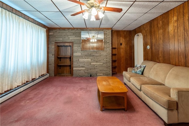 2509 Spring St, Arlington, PA 15210 - living area with carpet flooring, wood walls, ceiling fan, a baseboard radiator, and arched walkways