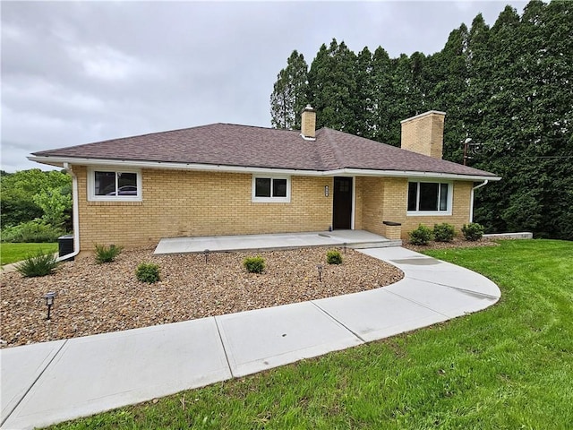 946 Herman Rd, Summit Twp But, PA 16002 - ranch-style home with a chimney, a front yard, brick siding, a patio area, and a shingled roof