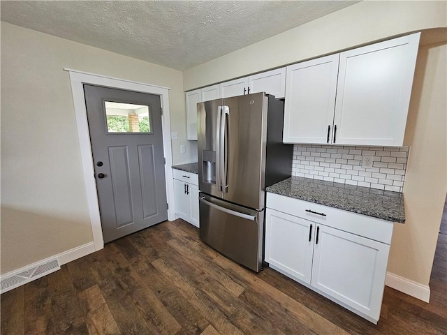 946 Herman Rd, Summit Twp But, PA 16002 - kitchen featuring stainless steel fridge with ice dispenser, white cabinetry, dark wood finished floors, dark stone countertops, and decorative backsplash