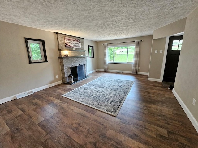 946 Herman Rd, Summit Twp But, PA 16002 - unfurnished living room with a textured ceiling, wood-type flooring, and a fireplace