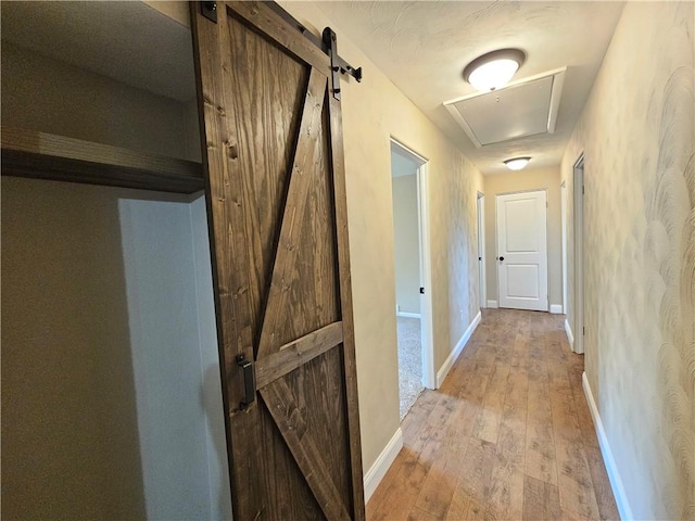 946 Herman Rd, Summit Twp But, PA 16002 - corridor with light wood-style flooring, attic access, and a barn door