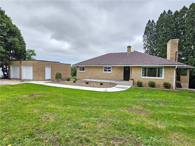 946 Herman Rd, Summit Twp But, PA 16002 - ranch-style house featuring a chimney, brick siding, an outbuilding, a front lawn, and a garage