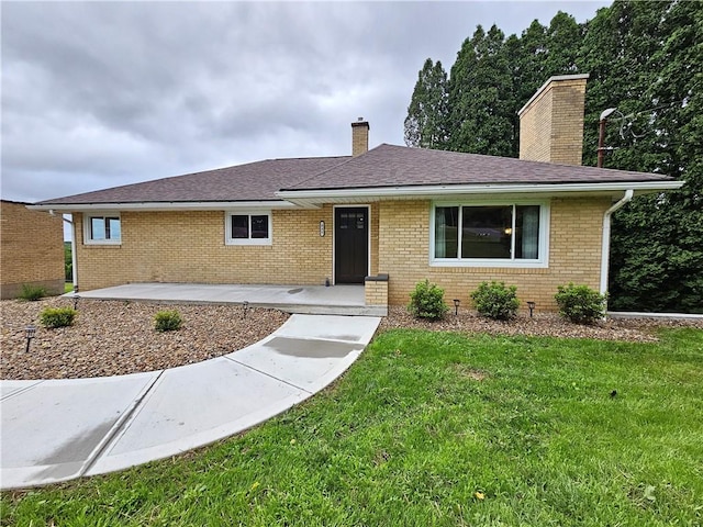 946 Herman Rd, Summit Twp But, PA 16002 - single story home featuring a chimney, a front yard, brick siding, and a shingled roof