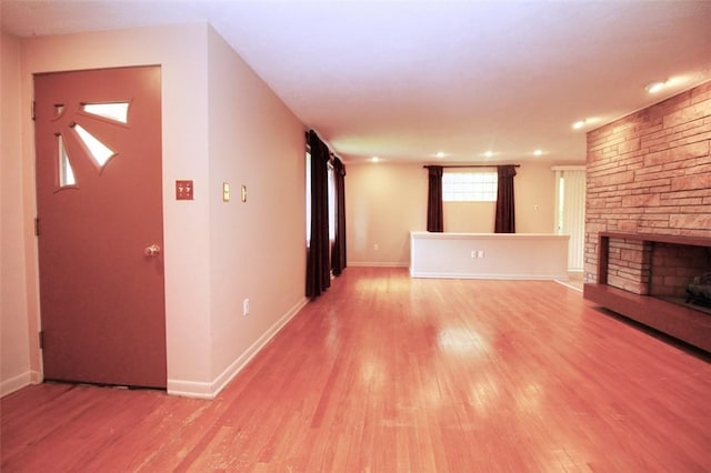 202 Dominican Way, Zelienople Boro, PA 16063 - unfurnished living room with light wood-type flooring and a fireplace