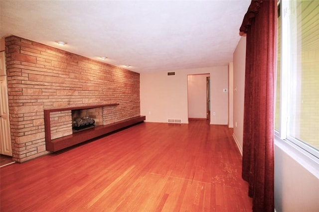 202 Dominican Way, Zelienople Boro, PA 16063 - unfurnished living room with a fireplace and wood finished floors