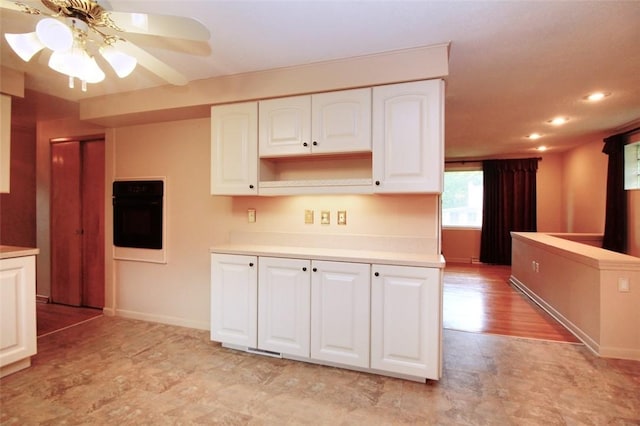 202 Dominican Way, Zelienople Boro, PA 16063 - kitchen with black oven, light countertops, white cabinetry, recessed lighting, and a ceiling fan