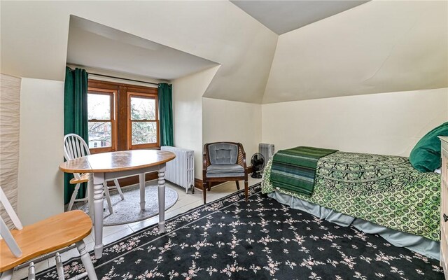 609 N Beatty, East Liberty, PA 15206 - living area with radiator, tile patterned floors, and vaulted ceiling