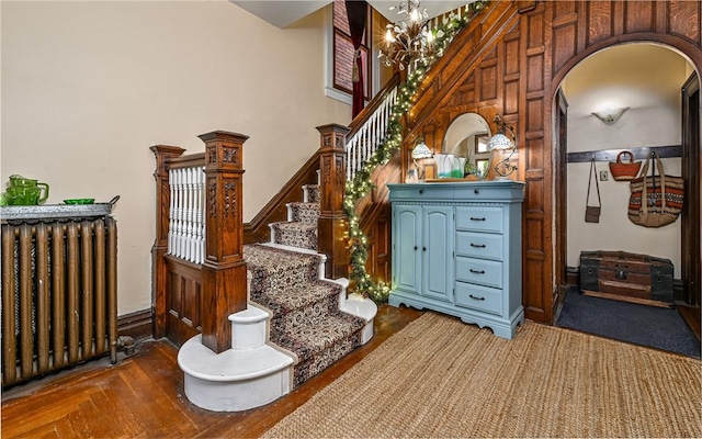 609 N Beatty, East Liberty, PA 15206 - staircase with radiator heating unit, arched walkways, wood finished floors, and a chandelier