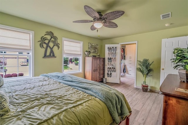 2616 Chalet Ln, South Park, PA 15129 - bedroom with multiple windows, wood finished floors, a walk in closet, and ceiling fan
