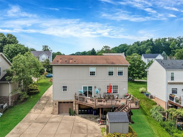 2616 Chalet Ln, South Park, PA 15129 - rear view of house with a garage, a deck, driveway, a lawn, and a storage shed