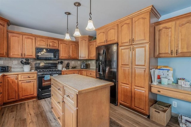 2616 Chalet Ln, South Park, PA 15129 - kitchen with black appliances, light countertops, wood finished floors, and tasteful backsplash