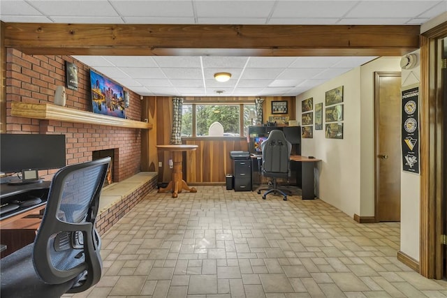 285 Old Plank Rd, City Of But Se, PA 16002 - home office with a drop ceiling, brick patterned flooring, wood walls, and a brick fireplace