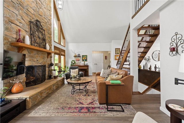 10737 Babcock Blvd, Pine Twp Nal, PA 15044 - living room with a towering ceiling, wood finished floors, stairs, and a stone fireplace