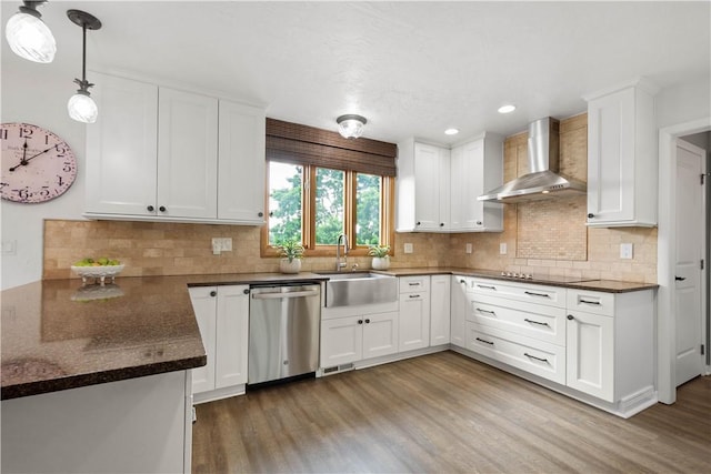 10737 Babcock Blvd, Pine Twp Nal, PA 15044 - kitchen with stainless steel dishwasher, wall chimney range hood, light wood-style flooring, white cabinetry, and decorative backsplash