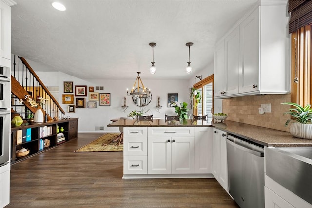 10737 Babcock Blvd, Pine Twp Nal, PA 15044 - kitchen with stainless steel appliances, a peninsula, a chandelier, backsplash, and white cabinetry