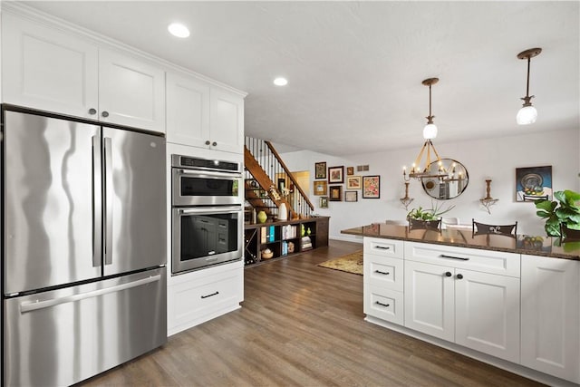 10737 Babcock Blvd, Pine Twp Nal, PA 15044 - kitchen with stainless steel appliances, white cabinets, dark wood-style floors, a chandelier, and hanging light fixtures