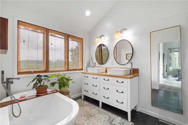 10737 Babcock Blvd, Pine Twp Nal, PA 15044 - bathroom with vaulted ceiling, double vanity, a freestanding tub, and tile patterned flooring